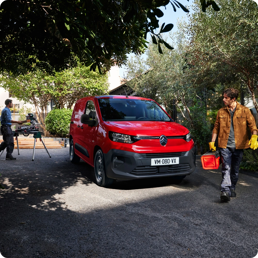 Rear three-quarter view of the Citroën ë-C3 Van with the tailgate and passenger door open, highlighting cargo accessibility, versatile loading solutions and SUV-inspired styling.