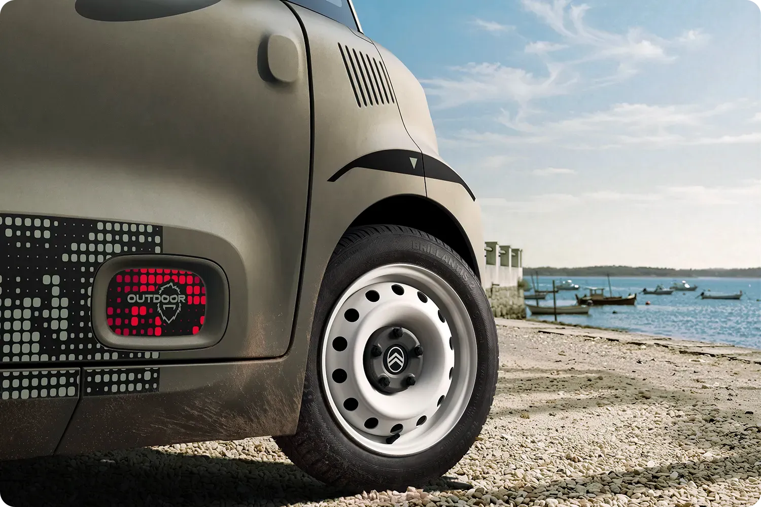 Gros plan sur le passage de roue de Citroën Ami Outdoor, au design compact, électrique et accessible et au style innovant pour les aventures sur le littoral